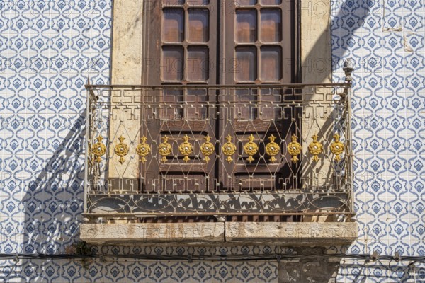 Facade of buildings decorated with tiles, azulejos, coloured tiles on facades, in Tavira, old town, in the east of the Algarve, Portugal