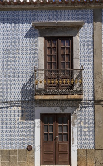 Facade of buildings decorated with tiles, azulejos, coloured tiles on facades, in Tavira, old town, in the east of the Algarve, Portugal