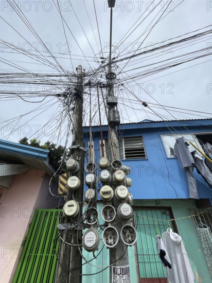Infrastructure, energy supply, electricity, power lines, electricity meters of various houses, San Carlos, Negros Occidental, Philippines