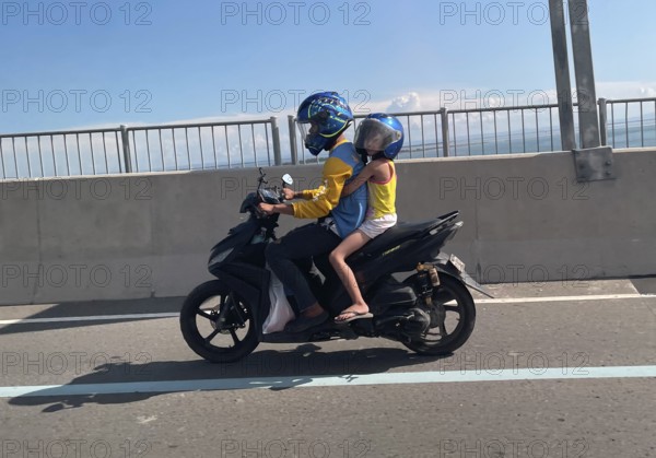 Father with child on motorbike, Cebu City, Cebu, Philippines