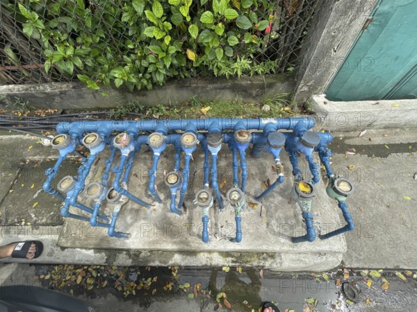 Infrastructure, water pipes and water meters of various houses, San Carlos, Negros Occidental, Philippines