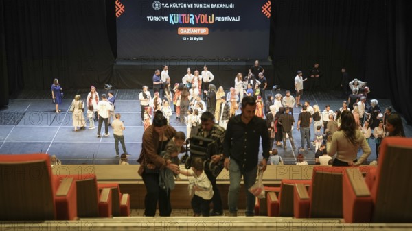 Audience members gather inside the theater before the start of the Fire of Anatolia show in Gaziantep. The Turkish dance ensemble, founded by Mustafa Erdogan, is one of the largest in the world with more than 120 dancers, Gaziantep, Gaziantep, Türkiye