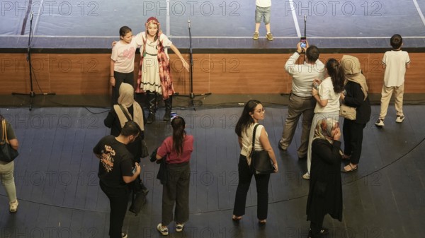 Audience members gather inside the theater before the start of the Fire of Anatolia show in Gaziantep. The Turkish dance ensemble, founded by Mustafa Erdogan, is one of the largest in the world with more than 120 dancers, Gaziantep, Gaziantep, Türkiye