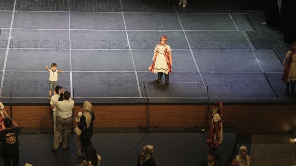 Audience members gather inside the theater before the start of the Fire of Anatolia show in Gaziantep. The Turkish dance ensemble, founded by Mustafa Erdogan, is one of the largest in the world with more than 120 dancers, Gaziantep, Gaziantep, Türkiye