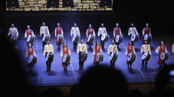 Dozens of members of Fire of Anatolia perform a drumming sequence during a cultural festival at Gaziantep University. The troupe is one of the largest dance ensembles in the world and includes 120 members, Gaziantep, Gaziantep, Türkiye
