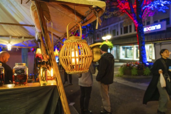 Atmospheric night-time street scene with decorative lanterns and market stalls, Sindelfingen, Böblingen district, Germany