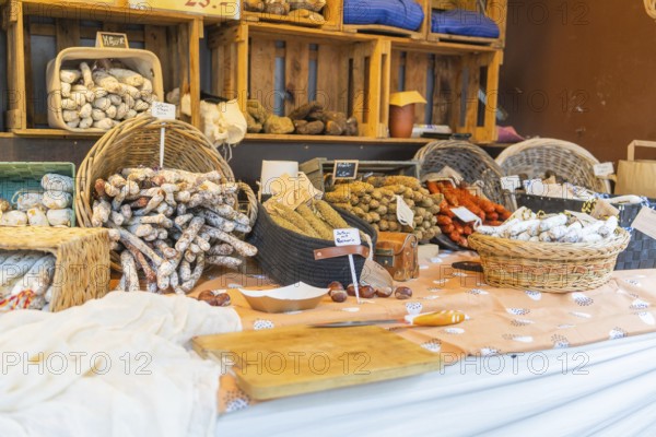 Various types of sausage presented on a market stall with baskets and wooden crates, Sindelfingen, Böblingen district, Germany