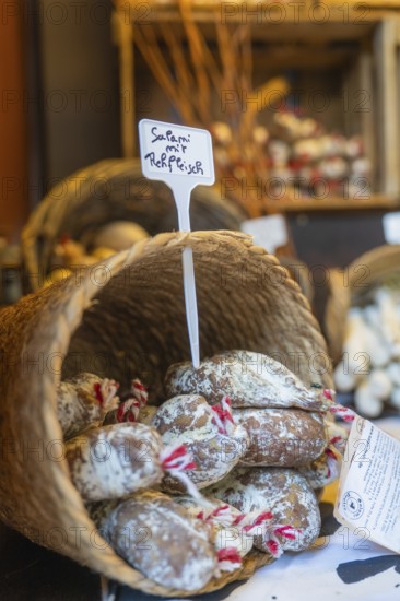 Basket of salami at a market stall with rustic products, Sindelfingen, Böblingen district, Germany