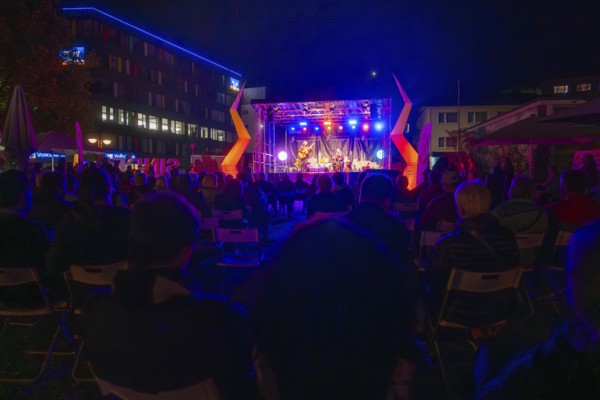 Concert stage illuminated at night with audience and atmospheric lighting effects, Sindelfingen, Böblingen district, Germany