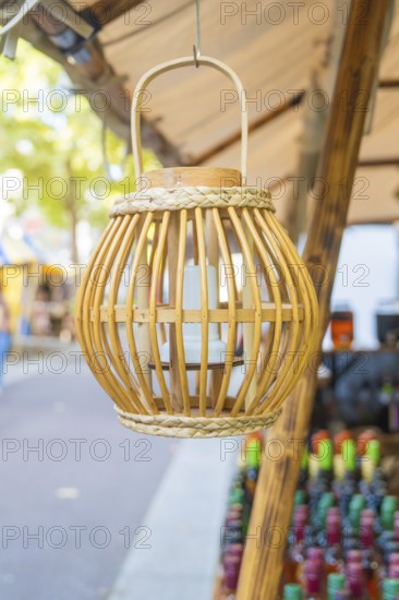 Wooden lantern hanging from a market stall with colourful bottles, Sindelfingen, Böblingen district, Germany