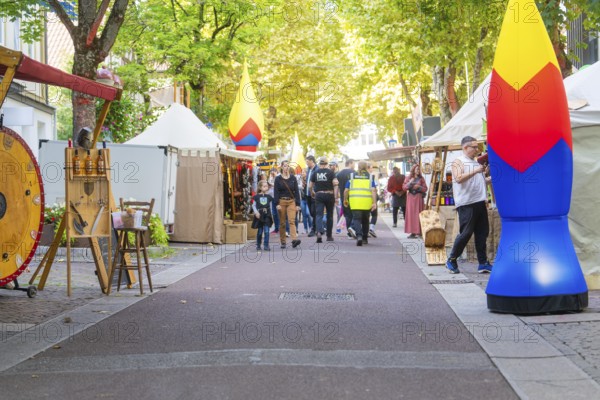 Lively market scene with people and stalls under trees, Sindelfingen, Böblingen district, Germany