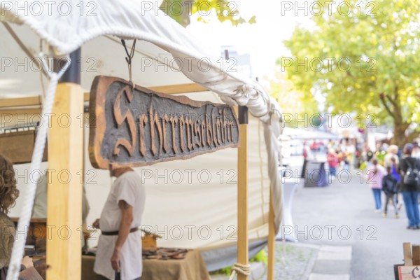 Sign above a market stall in a busy street, Sindelfingen, Böblingen district, Germany