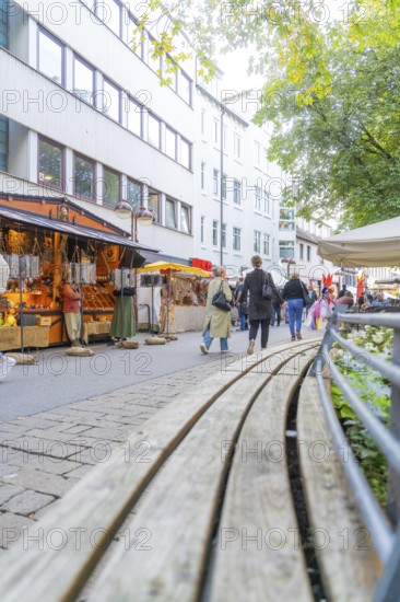 People stroll past stalls in a city with modern architecture, Sindelfingen, Böblingen district, Germany