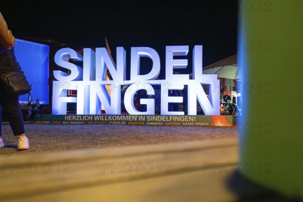 Illuminated welcome sign at night with colourful surroundings and festive atmosphere, Sindelfingen, Böblingen district, Germany