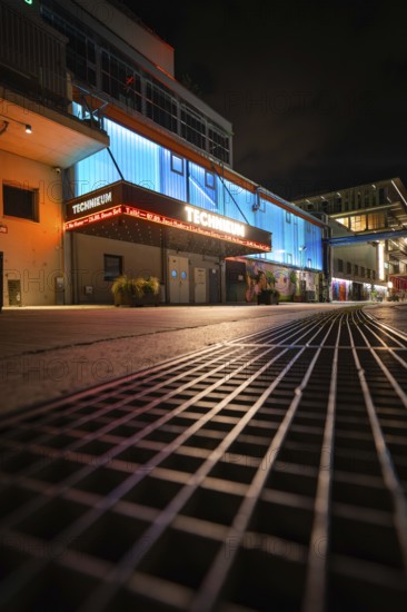 Night shot of an illuminated urban environment with modern buildings and architecture, Munich, Germany