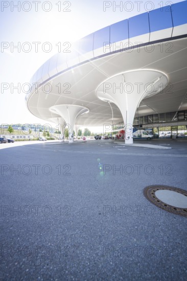 Curved, modern multi-storey car park structure with columns in daylight, Munich, Germany