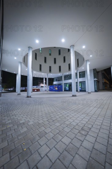 Modern architecture illuminated at night, focus on columns, Munich, Germany