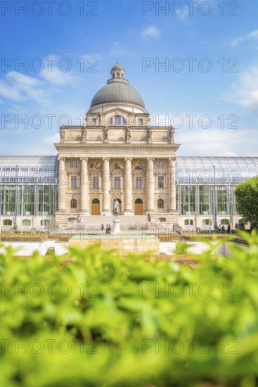 Large building with dome and columns, surrounded by plants, Munich, Germany