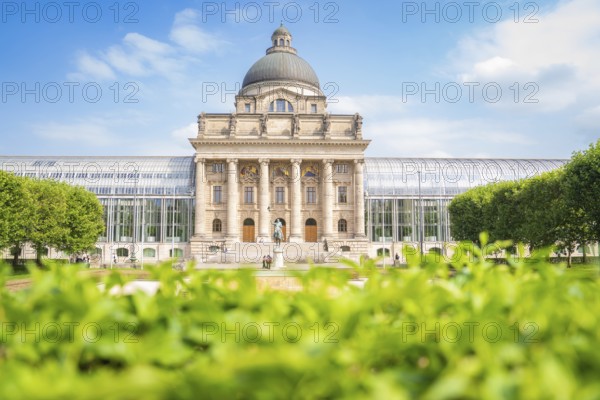 Large building with dome, surrounded by green spaces, cloudless sky and impressive architecture, Munich, Germany