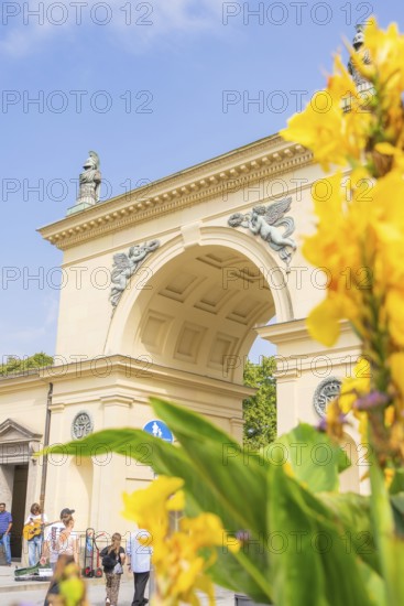 ArchiDecoration, historical architecture with yellow flowers in the foreground under a blue sky, Munich, Germany
