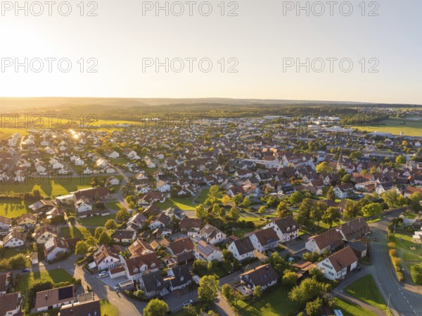 Aerial view of a village at sunset with densely built-up houses and rural flair, Althengstett, district of Calw, Germany