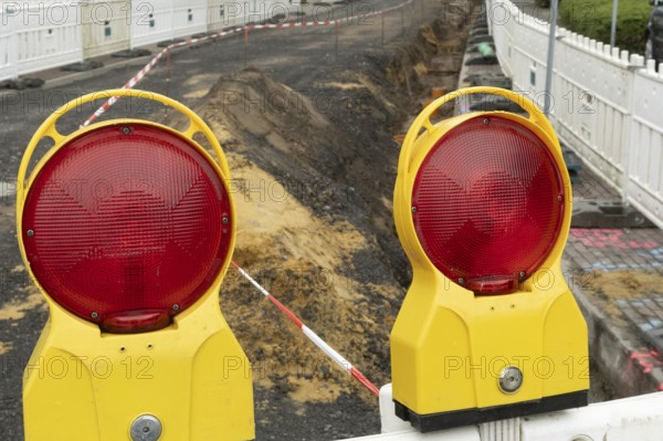 Borken, NRW, Germany, Red warning lights marking a construction site, ensuring safety with barrier tape
