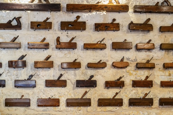 Plenty of different carpenter's planes exhibited on wall, Malta