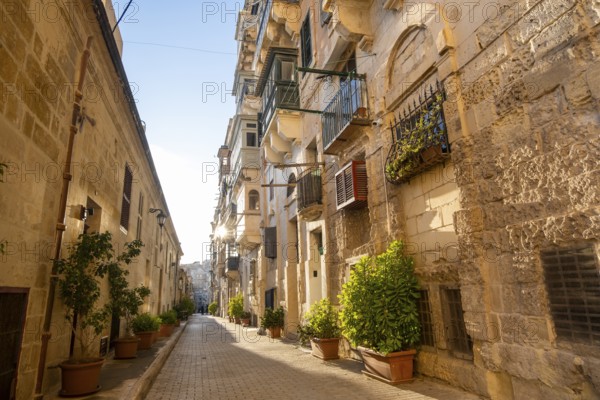 Street with wonderful historic houses with colorful wooden balconies in La Valletta, capital city of Malta