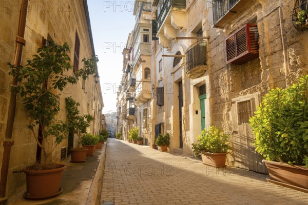 Street with wondeful historic houses with colorful wooden balconies in La Valletta, capital city of Malta