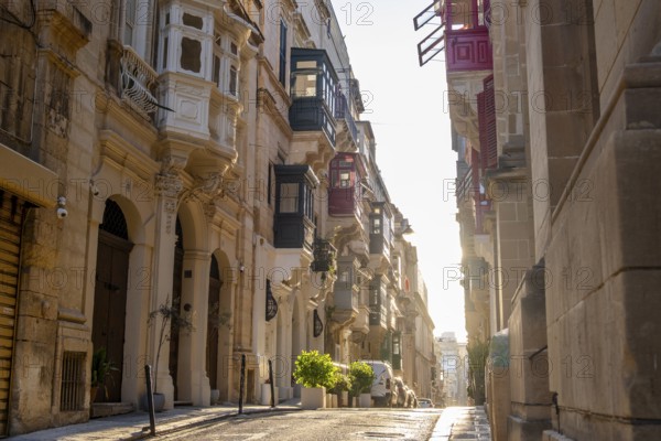 Street with wonderful historic houses with colorful wooden balconies in La Valletta, capital city of Malta