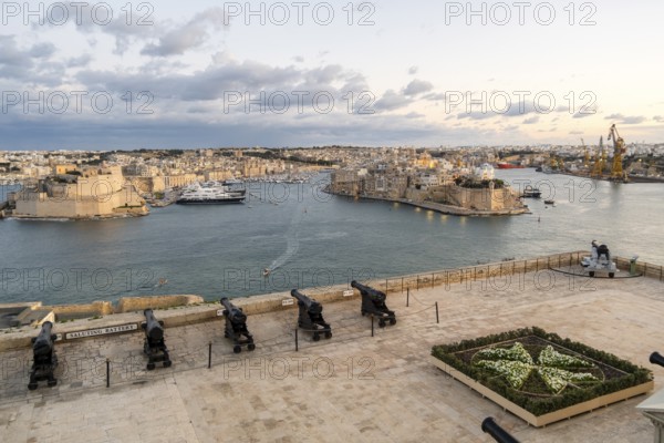 Beautiful sunset view of Valletta with a cannons in the foreground, capital city of Malta