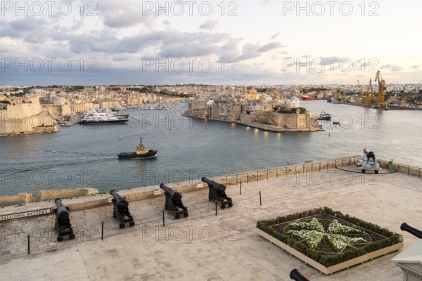 Beautiful sunset view of Valletta with a cannons in the foreground, capital city of Malta