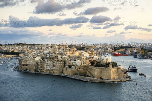 Beautiful sunset view of Valletta with Saint Angelo Fortress, capital city of Malta