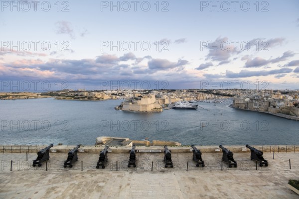 Beautiful sunset view of Valletta with a cannons in the foreground, capital city of Malta