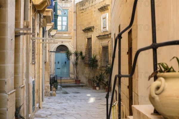 Street with amazing, wonderful historic houses with blue wooden balconies in La Valletta, capital city of Malta
