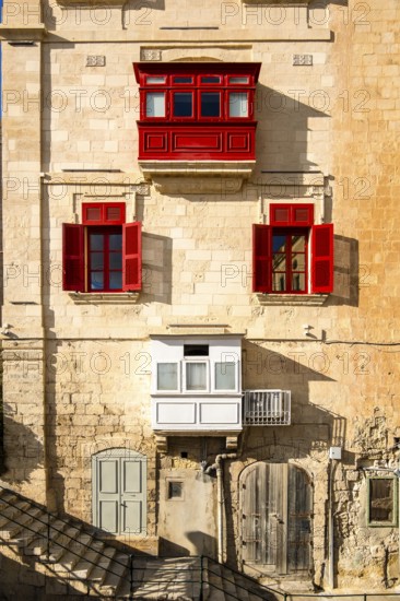 Amazing, wonderful historic houses with red wooden balconies in La Valletta, capital city of Malta