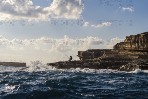 Coast with fishermen next to Marsaxlokk, southern part of Malta