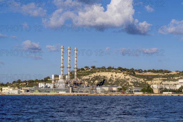 Waterfront power station against blue sky, with copy space, near to Marsaxlokk, Malta