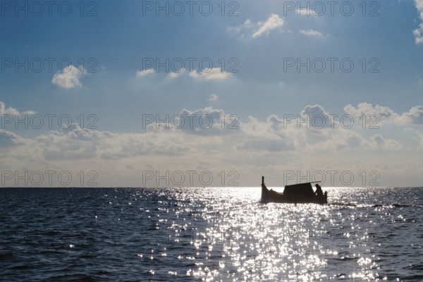 Silhouette of Maltese boat on Mediterranean Sea by Marsaxlokk, south of Malta