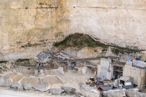 Limestone Quarry with Industrial Machinery in a Cliffside Setting in Malta