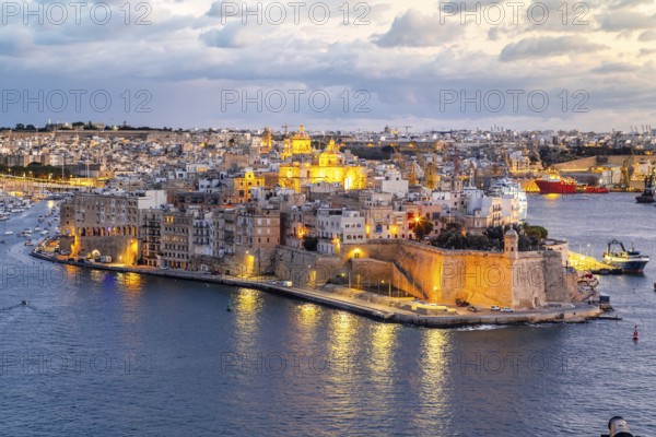 Beautiful evening view of illuminated Valletta, Birgu with Saint Angelo Fortress, capital city of Malta