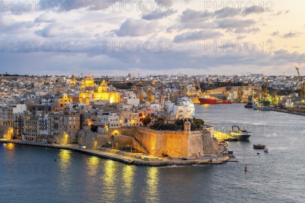 Beautiful evening view of illuminated Valletta, Birgu with Saint Angelo Fortress, capital city of Malta