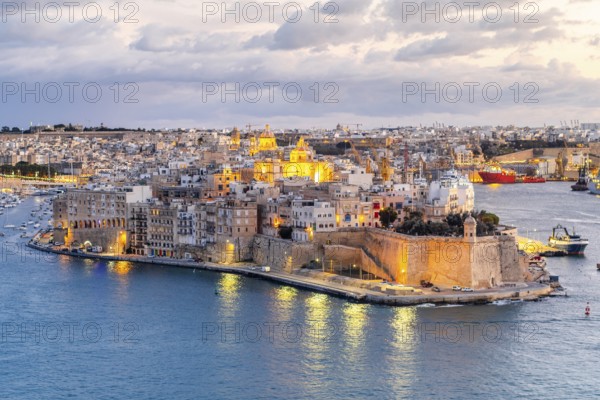 Beautiful evening view of illuminated Valletta, Birgu with Saint Angelo Fortress, capital city of Malta