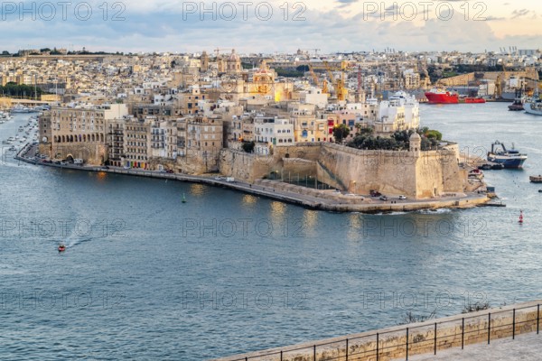 Beautiful sunset view of Valletta city with Saint Angelo Fortress, capital city of Malta