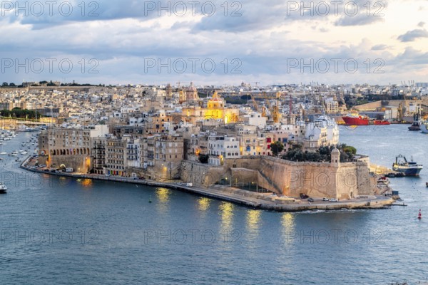 Beautiful evening view of illuminated Valletta, Birgu with Saint Angelo Fortress, capital city of Malta