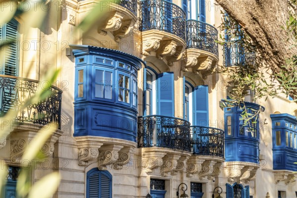 Street with amazing historic houses with colorful wooden balconies in La Valletta, capital city of Malta