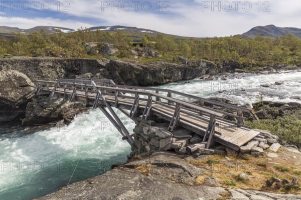 Wooden footbridge over the river Sjoa, Jotunheimen National Park, Tessanden, Innlandet, Norway