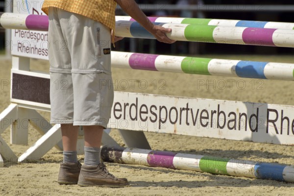 Erecting an obstacle course at an equestrian event, Rhineland-Palatinate, Germany