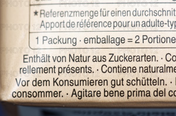 List of ingredients on a carton of oat milk. Focus on indication of sugar content