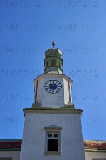 Historic clock tower against a bright blue sky. Baroque architecture with clear lines, brewhouse am Schloss, Regensburg, Bavaria, Germany